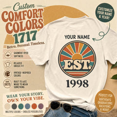 A beige t-shirt featuring a retro sunburst graphic with the text YOUR NAME above it and EST 1998 below, surrounded by promotional text.