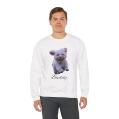 A man wearing a white crewneck sweatshirt printed with a photo of a white dog and the name Buddy, paired with dark grey trousers.